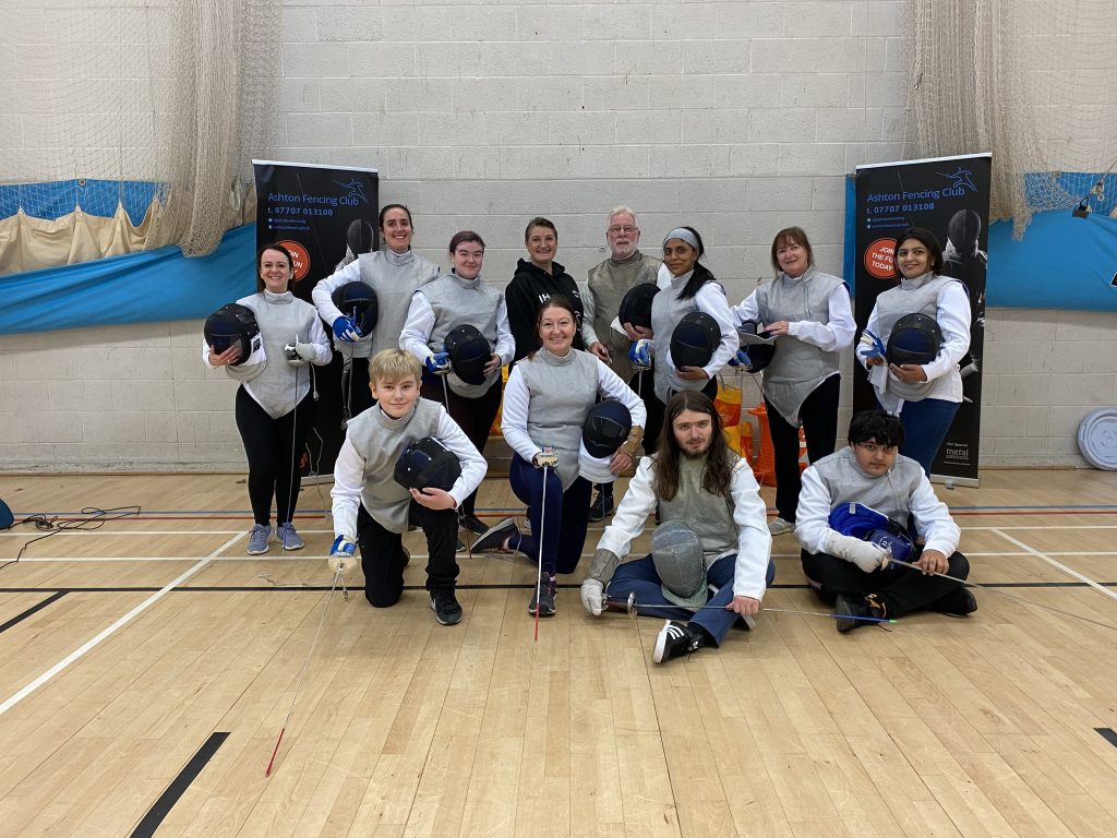 Group of fencers posing for a club night photograph.