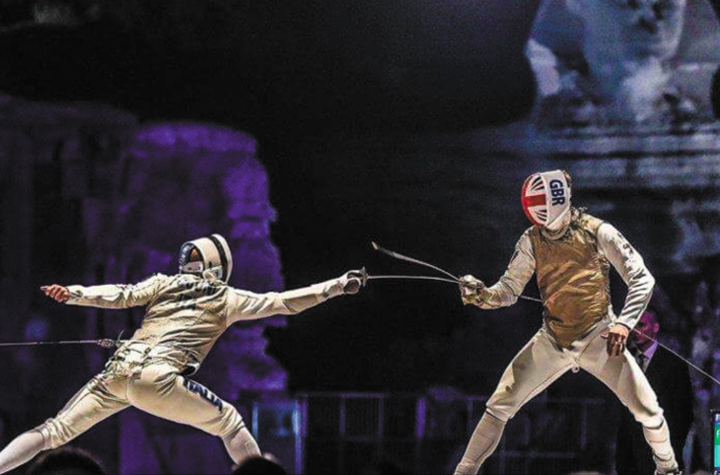 Richard Kruse fencing in Cairo for team GB and taking a lunge hit from his opponent.